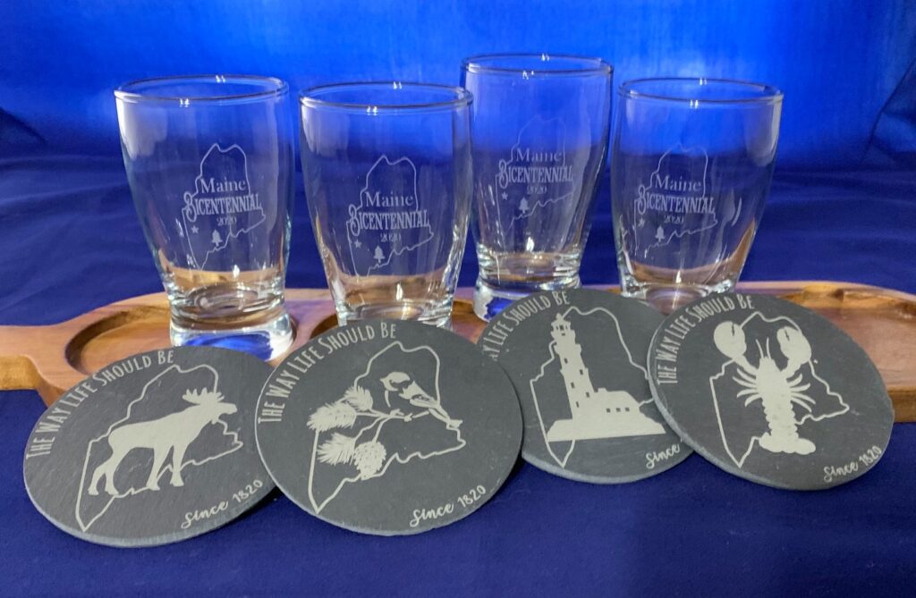 Engraved tasting glasses and slate coasters for a wood flight board used for serving small tasting portions of craft bear.