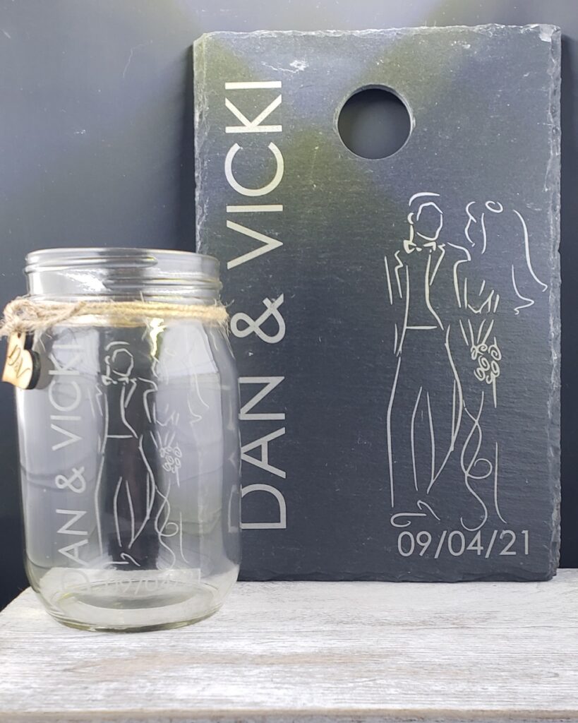 Slate cheese board and drinking jar personalized as a wedding gift set for a bride and groom.
