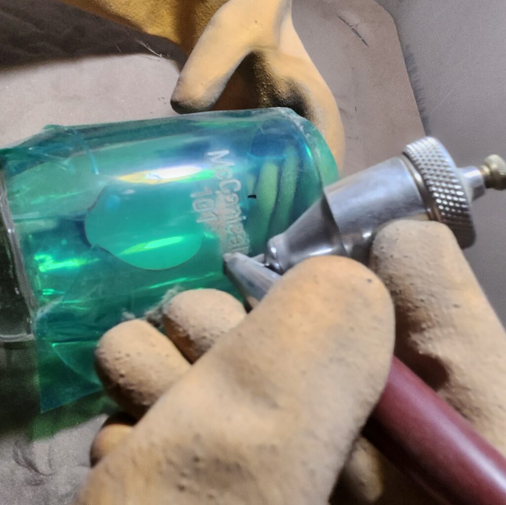 Custom Engraving Services using fine sand etching on a glass